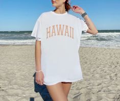 The perfect beachy, retro Hawaii shirt! This tshirt is super comfy and soft, and has a very cool aesthetic style. This shirt is true to size. For an oversized look size up 2/3 sizes from your normal size. Please check the product dimensions in the photo section, to confirm the right size for you. CUSTOMIZATION: If you would like this design in another color or on another medium such as a sweatshirt, hat, socks, bag, poster, wall decal, poster etc. Please feel free to reach out to me and let me k Oversized Summer Tops For Leisure, Casual White T-shirt For Vacation, Casual Beach Season Tops, Casual Beach Tops For Leisure, Casual Beach Season Tops For Leisure, Casual Tops For Beach Season Leisure, Oversized White Top For The Beach, Oversized White Vsco Style Tops, Oversized White Vsco Top