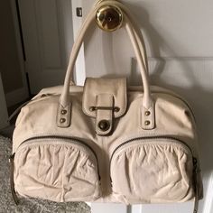 Brand New, Never Used! Beautiful Buttery Soft Ivory Lambskin Leather With Gold Leather Accents. Solid Brass Hardware, Two Exterior Zip Pockets, One Large Interior Zip Pocket, Four Small Interior Pockets, Suede Lining, Dual Top Handles With Brass Studs,Exterior Zip Closure, Heavy Duty Zippers With Studded Tassel Pulls, Turn Lock And Exterior Logo Plate. This Is An Absolutely Gorgeous Handbag. Been Kept In Dust Bag Since Purchase, Plastic Still On Metal Logo Plate! Smoke Free And Pet Free Home. Beige Leather Satchel For Errands, Cream Soft Leather Satchel With Double Handle, Cream Top Handle Satchel In Soft Leather, Cream Soft Leather Top Handle Satchel, Cream Satchel With Zipper Closure For Travel, Cream Satchel With Zipper For Travel, Cream Satchel For Travel With Zipper Closure, Cream Leather Satchel For Daily Use, Casual Cream Leather Shoulder Bag