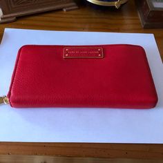 100% Cow Leather, Imported, Polyester Lining, Four Card Slots, One Slip Pocket. Brand New With Tags. This Is A Vibrant And Rich Red Wallet! So Soft And Beautiful That It Can Also Be Used As A Clutch, If You Want To Show It Off! It Can Hold Everything You Would Want To Put In A Wallet Even A Phone. It Features The Logo Plaque At Front, Polished Brass Tone Hardware. Lined With Red Logo-Jacquard Fabric; Three-Compartment Gusseted Interior Features Two Bill Pockets, Twelve Card Slots, One Slip Pocke Luxury Red Wallet With Zipper Closure, Luxury Red Wallets With Zipper Closure, Designer Red Wallet For Travel, Designer Red Wallet For Daily Use, Red Designer Wallets For Daily Use, Bags Marc Jacobs, Too Hot To Handle, Red Wallet, Marc Jacobs Bag