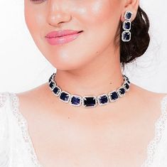 Sapphire Choker is a statement piece featuring navy blue stones and American diamonds.  The contemporary design adds a touch of elegance, making it perfect for weddings or as an anniversary gift. This blue stone tennis necklace set is a sophisticated choice for any special occasion. *𝐏𝐑𝐎𝐃𝐔𝐂𝐓 𝐃𝐄𝐓𝐀𝐈𝐋* * 𝐌𝐚𝐭𝐞𝐫𝐢𝐚𝐥: Brass * 𝐏𝐥𝐚𝐭𝐢𝐧𝐠: Gold Plated * 𝐒𝐭𝐨𝐧𝐞: AAA-quality CZ Diamond & Sapphire *𝐃𝐈𝐌𝐄𝐍𝐒𝐈𝐎𝐍𝐒* *𝐍𝐞𝐜𝐤𝐥𝐚𝐜𝐞* * 𝐖𝐞𝐢𝐠𝐡𝐭: 41 gm * 𝐃𝐞𝐬𝐢𝐠𝐧 𝐋? Sapphire Diamond Necklace Shane Co., Sapphire Choker, Blue Diamond Necklace, American Diamond Necklace Set, Blue Wedding Jewelry, India Wedding, Blue Stone Necklace, American Diamond Necklaces, Blue Sapphire Necklace