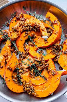 roasted pumpkins with pecans and herbs in a bowl