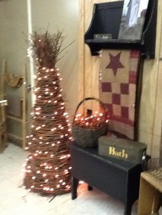 a small christmas tree next to a black bench