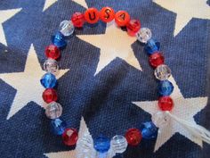 This is a USA Beaded Bracelet.  It has red USA letter beads. It has red, white, and blue 6mm faceted beads. It was made with .8mm sturdy stretch string. I tie it several times to prevent breakage. It fits girls ages 5-9. It stretches to fit on the wrist. It would make a great addition to a girls Fourth of July outfit. It would make a cute gift for a Birthday. All items are ready to be shipped I do combined shipping. Items ship in 2-5 business days. Check out more items at: http://www.etsy.com/sh Patriotic Bracelet, Fourth Of July Outfit, Bracelets For Girls, Easter Bunny Girl, Kids Bracelets, Christmas Bracelet, Gold Bracelet For Women, White Gold Bracelet, Stocking Stuffer Gifts