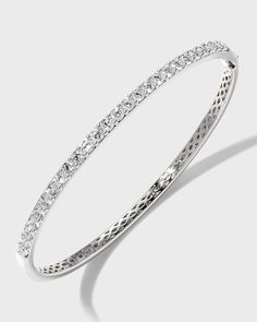 Diamond fashion bangle from Memoire..Polished 18-karat white gold hardware..26 round-cut, prong-set G-H/SI diamonds..Hinged opening with fold-over clasp..1.97 total diamond carat weight. Fine Jewelry White Bangle With Single Cut Diamonds, White Bangle With Single Cut Diamonds, Timeless Bangle With Pave Setting For Formal Occasions, Diamond Bangle With Pave Setting, Diamond White Diamond Bangle With Pave Setting, Classic Hand Set Diamond White Bangle, Classic Diamond White Bangle Hand Set, Pave Set Cubic Zirconia Bangle, White Gold Diamond Cut Bangle Bracelet