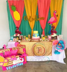 a birthday party with flamingos, pineapples and other decorations on the table