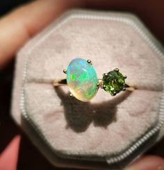 ABOUT PRODUCT:- Our Opal and Peridot Unique Ring is a breathtaking piece of jewelry, featuring a 10*14mm oval peridot and a 6mm round opal. The peridot's vibrant green hue perfectly complements the opal's iridescence, creating a stunning contrast. Crafted with precision and care, this ring is both durable and comfortable, making it perfect for everyday wear. The unique design ensures that it will be treasured for years to come. Stone: Opal & Peridot gemstone Opal size: 10*12 mm Peridot size: 6 m Opal And Peridot Ring, Peridot And Opal Ring, Elegant Green Opal Ring In 14k Gold, Exquisite Yellow Gold Opal Gemstone Ring, Fine Jewelry Ethiopian Opal Birthstone Rings, Fine Jewelry Rings With Ethiopian Opal Birthstone, Multi-stone Round Jewelry For May Birthstone, Exquisite Green Cabochon Jewelry, Yellow Gold Ethiopian Opal Multi-stone Jewelry