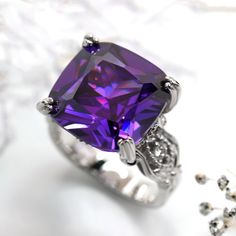 This beautiful Simulated Amethyst Ring, Sterling Silver Statement Ring for Women, Cushion Cut 10.5 Carat Vintage Cocktail Ring, Edwardian Engagement Ring by DoubleAccent is meticulously crafted in gleaming and durable Sterling Silver. Our stones are the highest quality diamond simulant that are polished, finely cut, loupe clean, and have an exactly similar appearance and as beautiful as to naturally occurring diamonds. All cubic zirconia stone weights are approximate and listed as diamond equiva Edwardian Engagement Ring, Vintage Cocktail Ring, Gold And Silver Rings, Statement Ring Silver, Diamond Simulant, Vintage Cocktail, Amethyst Stone, Quality Diamonds, Amethyst Ring