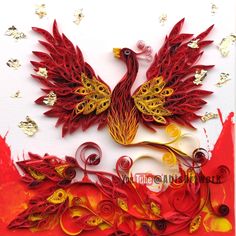 a red and yellow bird with gold accents on it's wings