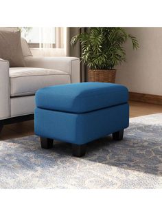 a blue ottoman sitting on top of a rug