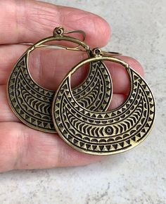 "boho earrings dangle brass open hoop earrings tribal earrings These large, oval hoops are antiqued brass with a recessed, tribal-like pattern, which is on both sides. Hook ear wires are antiqued brass. Length of earrings from top of ear wires is 2 1/4\". Hoops measure 1 1/2\" x 1 5/8\". You can enter my shop here: gypsydangles.etsy.com" Bohemian Round Brass Hoop Earrings, Bohemian Bronze Hoop Earrings In Brass, Bohemian Bronze Brass Hoop Earrings, Bohemian Bronze Hoop Earrings, Bohemian Bronze Nickel-free Hoop Earrings, Bohemian Bronze Metal Earrings, Bohemian Antique Gold Brass Earrings, Bohemian Antique Gold Nickel-free Earrings, Bronze Metal Hoop Earrings For Pierced Ears