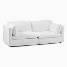 a white couch sitting on top of a white floor