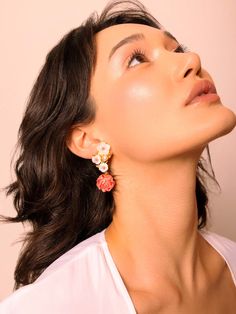 Introducing our Sakura Flower Earrings – a true work of art crafted with care and attention. Delicate white sakura flowers in full bloom, paired with a pink freshwater pearl and dangling pink coral rose create a unique and elegant design. Hypoallergenic 925 sterling silver and 18k gold plating ensure durability and comfort for sensitive skin. Materials: 18k gold plated 925 sterling silver, pink freshwater pearls, coral Closure: Post back Allergy Information: Hypoallergenic Measurements: width: 0 Dangle Flower Earrings With 3d Flowers, Feminine 3d Flower Earrings, Feminine Blossom-colored Wedding Jewelry, Feminine Flower Charm Earrings, Feminine Flower Jewelry With 3d Flowers, Elegant Pink Cluster Earrings, Elegant Pink Jewelry With 3d Flowers, Feminine 3d Flower Jewelry, Feminine Flower Shaped Pearl Drop Earrings