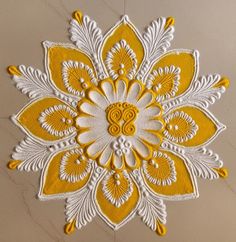 an intricate yellow and white design on a wall