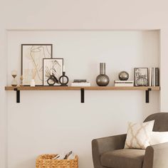 a living room filled with furniture and decor on top of a wooden shelf next to a chair