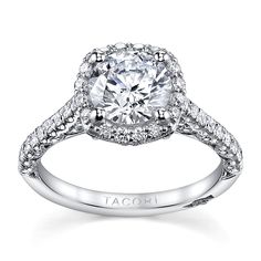 a diamond engagement ring with an intricate halo setting