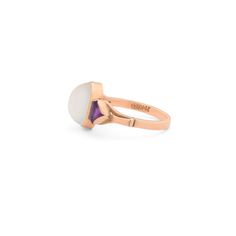 The Story A beautiful and luminous vintage ring done in 14 karat rose gold. At the center sits an oval shaped moonstone cabochon within a bezel setting. On either side is a triangular cuts amethyst adding a great pop of color. The center sits on a simple band. It measures 0.42 inches at center and looks great on the finger. Moonstones, which legend says bring the wearer good luck, are seen with adularescence, which this beautifully piece shows. The Specs Style Number: R2474 Vintage, circa 20th C Luxury Vintage Oval Cabochon Moonstone Ring, Antique Gold Moonstone Cabochon Ring, Antique Moonstone Cabochon Ring Gift, Antique Moonstone Ring, Oval Cabochon, Vintage Cabochon Amethyst Ring Gift, Moonstone Cabochon, Simple Band, 14k Rose Gold Ring, Oval Cabochon