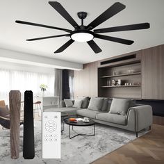 a living room with a ceiling fan and remote control in front of the couches