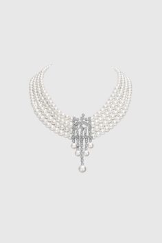 This sumptuous piece of jewelry features a retro-elegant yet slightly modern style that complements the lavish garments, reminiscent of the roaring 1920s. Features: Multi layer imitation pearls Rhinestone studded shimmering pattern Pearl strand lengths: 6.5", 6.9", 7.3", 7.9" 6-8mm pearls 1920 Accessories, Roaring 20s Jewelry, 20s Jewelry, Rose Gold Pearl Necklace, Flapper Accessories, 1920s Necklace, Roaring 1920s, Multi Strand Pearl Necklace, 1920s Jewelry