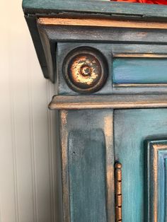 an old blue painted cabinet with knobs and handles