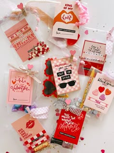 many valentine's day cards are on display in plastic bags with ribbons and tags