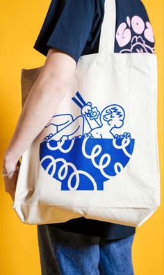 a person carrying a tote bag with an image on it