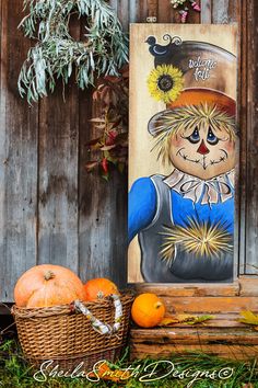 a painting of a scarecrow and pumpkins in front of a wooden fence