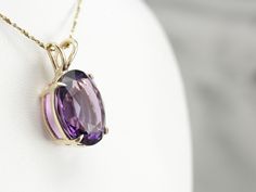 This amethyst gem is bursting with brilliant purple color! The oval cut faceting optimizes its luster, and the yellow gold only compliments the stone with its warm hue. This pendant could be worn everyday or for special occasions! This pendant does not come with the chain shown. Please feel free to contact us, we will help you find the perfect chain for your style and budget! Metal: 14K Yellow Gold Gem: Amethyst 14.00 Carats Gem Measurements: 17.7 x 14.5 mm, Oval Measurements: 26 x 15 mm, with b Luxury Amethyst Large Pendant Jewelry, Luxury Amethyst Oval Pendant Jewelry, Classic Oval Purple Gemstones, Purple Oval Classic Gemstones, Classic Purple Oval Gemstones, Classic Oval Amethyst Necklaces, Elegant Oval Purple Gemstones, Elegant Purple Oval Gemstones, Purple Oval Jewelry With Gemstone Accents