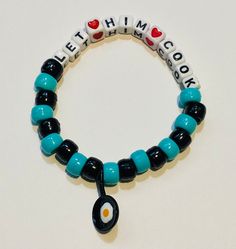 This rave kandi bracelet says "Let him cook" with an egg frying pan on it.  You may change the words or color of the beads if you'd like. Bed Bracelet Ideas, Rave Candy Ideas, Funny Kandi Bracelets Sayings, Kandi Collar, Rave Candies, Rave Candy Bracelets Ideas, Kandi Words, Funny Bracelet Ideas, Kandi Quotes