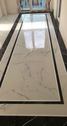 a hallway with black and white marble flooring