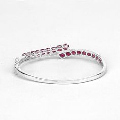 "Ruby Bangle, Natural Graduated Glass-Filled Ruby Rounds Cuff Bangle Bracelet for Women, Red Gemstone Bangle, July Birthstone Bangle for Her Flaunt yourself with this glass filled ruby bangle. The natural gemstones have a combined weight of 7.48 carats and are set in .925 sterling silver with rhodium plating. The vivid red hue of this bracelet adds a pop of color to any look! The understated design and vibrant stones makes this bracelet perfect for every occasion. ♥ Benefits of wearing Ruby gems Elegant Red Crystal Bangle Bracelet, Elegant Red Round Cuff Bracelet, Wedding Red Cuff Bracelet, Red Gemstone Bangle Cuff Bracelet, Red Gemstone Cuff Bracelet, Ruby Bangles, Tanzanite Bracelet, Gemstone Bangle, Cuff Bangle Bracelet