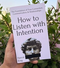 a person holding up a book about how to listen with intention