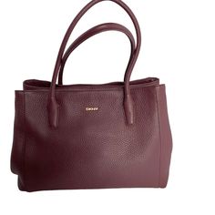 Very Nice Soft Pebbled Leather Purse, Bag Or Handbag By Dkny In Wine Color. This Color Goes With So Many Outfit Colors And Is A Great Every Day Bag. Great For The Fall And Winter. Very Practical As It Has Three Sections. The Middle Section Zips Open And Closed And On Either Side Of The Middle Is A Section That Snaps Shut. Great Bag To Store Your Items As The Three Sections Makes It Easy To Organize And Find Your Items. It Is Safe To Carry Because Of The Three Closing Compartments. It Has A Numbe Dkny Bags, Dkny Bag, Wine Color, Day Bag, Wine Colored, Purse Bag, Leather Purse, Fall And Winter, Leather Handbag