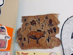 a piece of paper that has been decorated with animals and people on it, along with other items