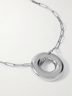 Laura Lombardi is renowned for its sculptural, contemporary jewelry that's designed with a focus on archival materials. This 'Terra' necklace is handmade from rhodium-plated recycled brass and comprised of slim, paperclip links strung with a sizable circular pendant. Timeless Metal Necklace With Polished Finish, Modernist Metal Necklace With Polished Finish, Modern Silver Chain Jewelry With Round Pendant, Modern Polished Metal Chain Necklace, Contemporary Sterling Silver Necklace With Polished Finish, Modern Metal Necklace With Polished Finish, Unique Metal Necklaces With Polished Finish, Modern Round Chain Necklace With Polished Finish, Metal Necklace With Round Pendant And Polished Finish