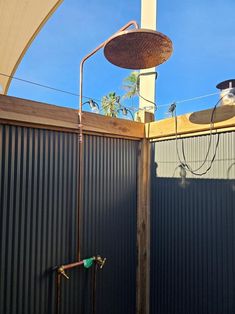 an outdoor shower is shown in front of a blue sky