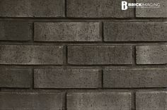 a brick wall that is made out of grey bricks