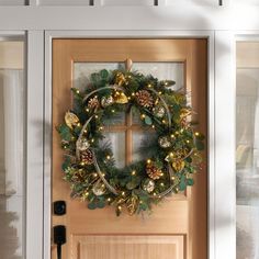 a christmas wreath is hanging on the front door