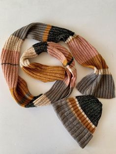 multicolored knitted scarfs laid on top of each other