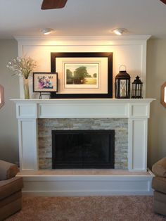 a living room with a fireplace and pictures on the mantle