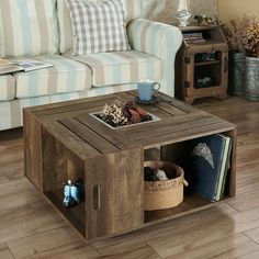 a living room with a couch, coffee table and bookshelf on the floor