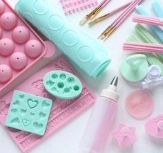 there are many crafting supplies on the table including plastic molds, pens and scissors