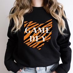 Cheer on the Bengals in a "Ohio Who Dey" crewneck.  A classically cool style, made from high quality materials, that provide a comfortable and long lasting fit.  - Unisex - 50% cotton, 50% polyester - Medium-heavy fabric - Loose fit - Sewn-in label - Runs true to size  Care Instructions: Do not bleach; Do not iron; Do not dryclean; Machine wash: cold; Tumble dry: low heat. Thank you for visiting ♡ Black School Spirit Sweatshirt With Crew Neck, Crew Neck T-shirt For Game Day In Fall, Fall Sports Fan Crew Neck Sweatshirt, Fall Sports Fan Sweatshirt With Crew Neck, Fall Crew Neck Sports Fan Sweatshirt, Black Crew Neck Sweatshirt For Sports Fans, Fall Team Spirit T-shirt With Crew Neck, Sports Fan Cotton Crew Neck Sweatshirt, Black Team Spirit Sweatshirt With Relaxed Fit