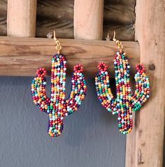 rainbow bead dangle cactus earrings. Casual Colorful Beaded Jewelry, Rainbow Dangle Earrings For Summer, Fun Adjustable Dangle Jewelry, Handmade Rainbow Casual Jewelry, Summer Rainbow Jewelry With Dangling Beads, Multicolor Large Beads Southwestern Jewelry, Southwestern Green Earrings With Colorful Beads, Trendy Multicolor Teardrop Jewelry, Southwestern Style Green Earrings With Colorful Beads