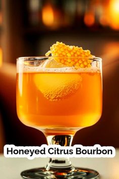 honeyd citrus bourbon cocktail in a glass with garnish on the rim and text that reads, honeyd citrus bourbon