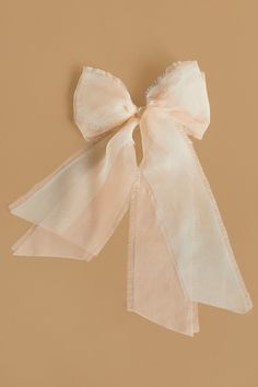 a white bow on a tan background