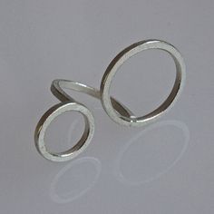 "This ring seems to float over the hand .  Its is quiet big but light and easy to wear. The ring is made of 2mm square wire in sterling silver. It is textured with the edges polished for a nice contrast. The diameter of the circles are ca. 24 mm and 16 mm. The ring shown is in ring size 12 EU or 6 US , but can be made in any size in 3 days. Just leave the ring size in \"message to seller \" when you make the purchase! As al my items are complete handmade I also can make this model  size variatio Sterling Silver Layered Necklace, Silver Door, Contemporary Jewellery Necklace, Circle Jewelry, Contemporary Ring, Geometric Jewelry, Bling Rings, Contemporary Jewellery, Designer Engagement Rings