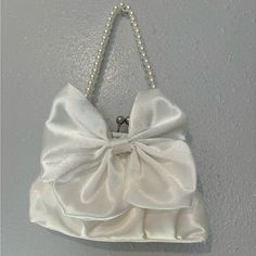 Brand New /Never Used. White Wristlet Style Satin Fabric Purse With Pearl Style Handle And Interchangeable Long Metal Chain Handle Included. Metal Clasp Closure. 8” X 2” At Bottom Of Bag/ 6” Wide At Metal Opening At Top. Envelope Handbag, Black Clutch Bags, Bow Purse, Fabric Purse, Oversized Clutch, Pearl Bow, White Clutch, Fabric Purses, Leather Fanny Pack