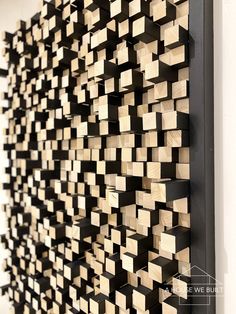 a wall made out of wooden blocks in the shape of squares