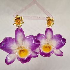 Natural flower earrings , real dry Orchid cover with resin .  All earrings are made from real Orchid hand made carefully selected dry and cover with shiny and transparent resin. Keep in mind that in nature any color change is very natural over time. With every flower is a little bit different some take a year long to lose some color some of them take longer, and sometime i use some colorful paint to give even more attractive options that stay for a long time. Unique pieces ,each flower is differ Handmade Orchid Earrings, Orchid Flower-shaped Earrings For Gift, Orchid Earrings, Yellow Orchid, Flowers Earrings, Flowers Purple, Transparent Resin, Orchid Flowers, Earrings Resin