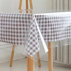 a white and brown checkered table cloth on a wooden chair